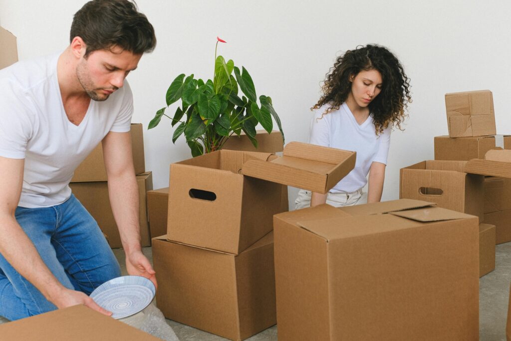 A couple is packing their household items in the concept of moving to Balham