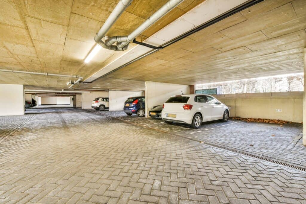 A parking garage with a few cars parked