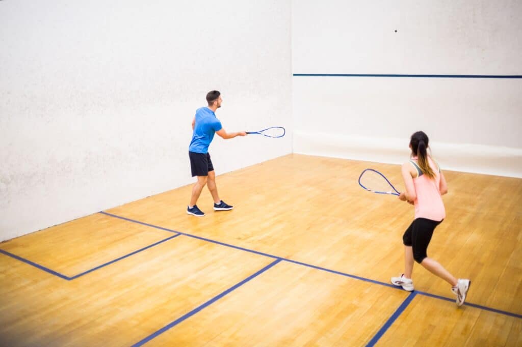 A couple is playing the game of squash