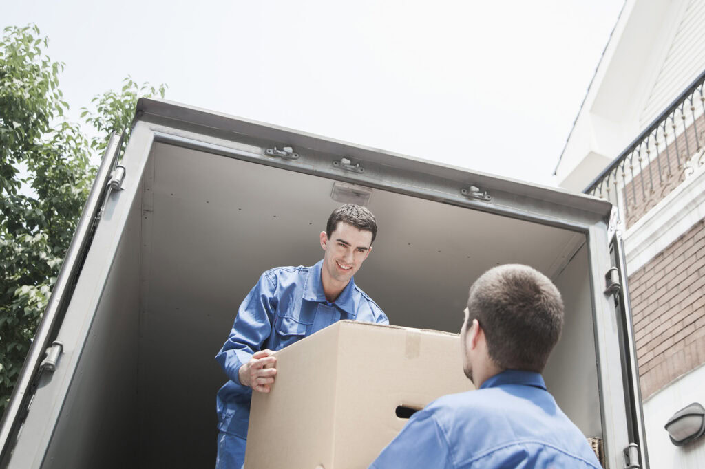 movers unloading a box from a van