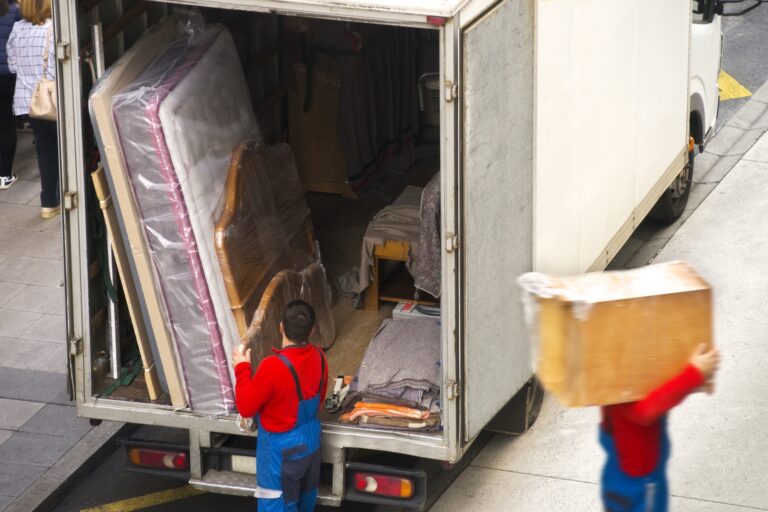 High-angle: professional mover loading furniture into the truck in the concept of 'What Are the Benefits of Using a Professional Home Removals Service in Balham'.